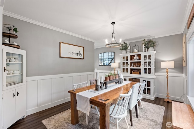 191 E Sterling Dr, Allyn, WA 98524 - dining area with a chandelier, a decorative wall, dark wood finished floors, crown molding, and a wainscoted wall