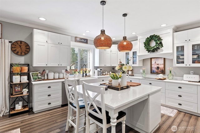 191 E Sterling Dr, Allyn, WA 98524 - kitchen with ornamental molding, light countertops, recessed lighting, white cabinets, and a breakfast bar area