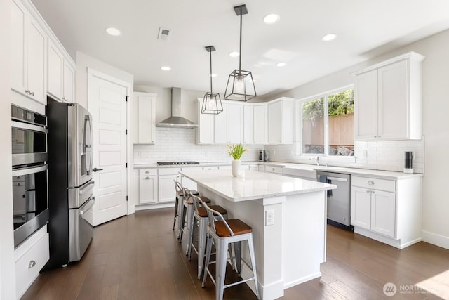 28611 NE 155th St, Duvall, WA 98019 - kitchen with wall chimney exhaust hood, appliances with stainless steel finishes, a center island, dark wood-style flooring, and recessed lighting