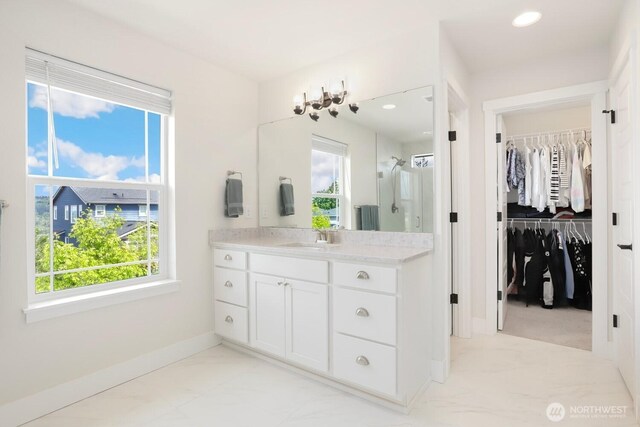 28611 NE 155th St, Duvall, WA 98019 - full bathroom with marble look tiles, plenty of natural light, baseboards, vanity, and recessed lighting