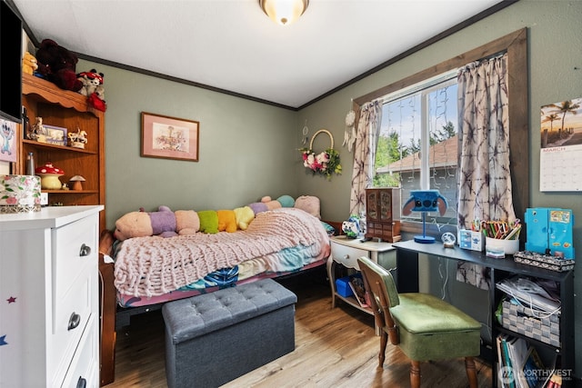 bedroom featuring ornamental molding and wood finished floors