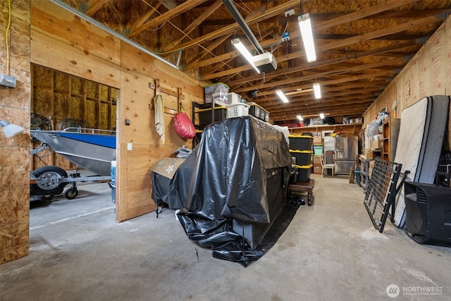 garage featuring a garage door opener and stainless steel fridge with ice dispenser