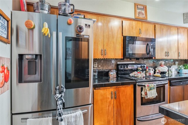 1016 Oak, Kelso, WA 98626 - kitchen with stainless steel appliances, dark countertops, decorative backsplash, and brown cabinets