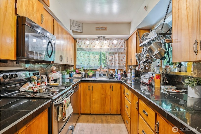 1016 Oak, Kelso, WA 98626 - kitchen featuring stainless steel electric range, black microwave, a sink, and brown cabinets