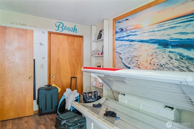 1016 Oak, Kelso, WA 98626 - misc room with wood finished floors and a textured ceiling