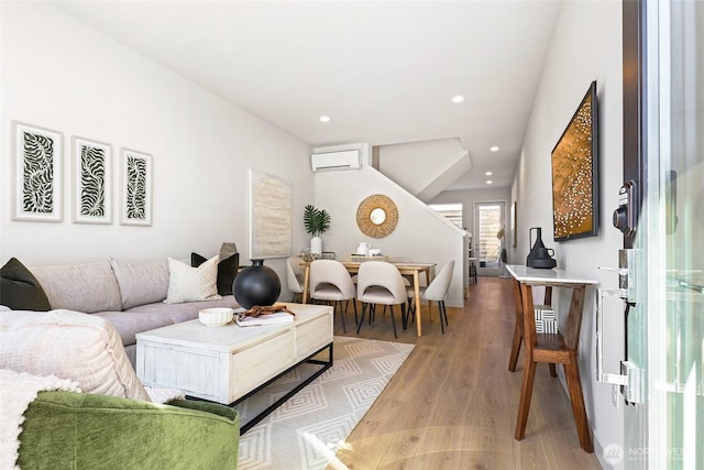 9752A Holman Rd NW, Seattle, WA 98117 - living room with a wall mounted air conditioner, light wood-style flooring, stairs, and recessed lighting