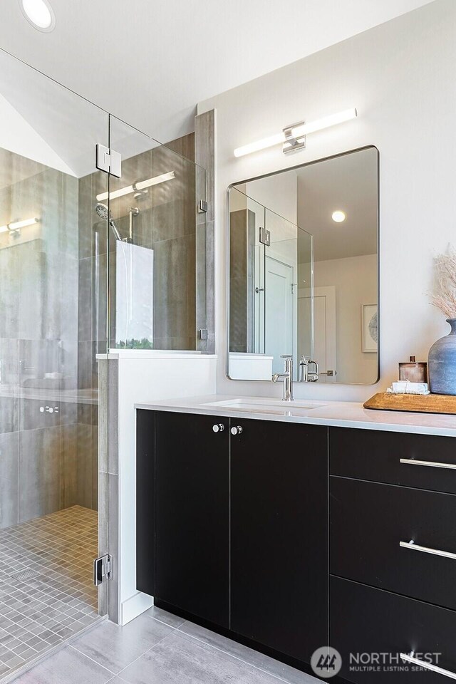 9752A Holman Rd NW, Seattle, WA 98117 - bathroom with a stall shower, tile patterned floors, and vanity