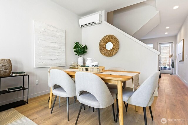 9752A Holman Rd NW, Seattle, WA 98117 - dining area featuring a wall unit AC, light wood-type flooring, stairs, recessed lighting, and baseboards