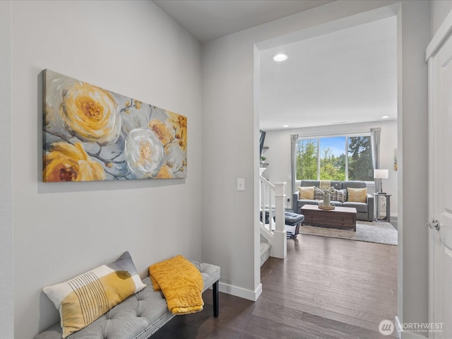 hallway featuring wood finished floors, stairs, recessed lighting, and baseboards