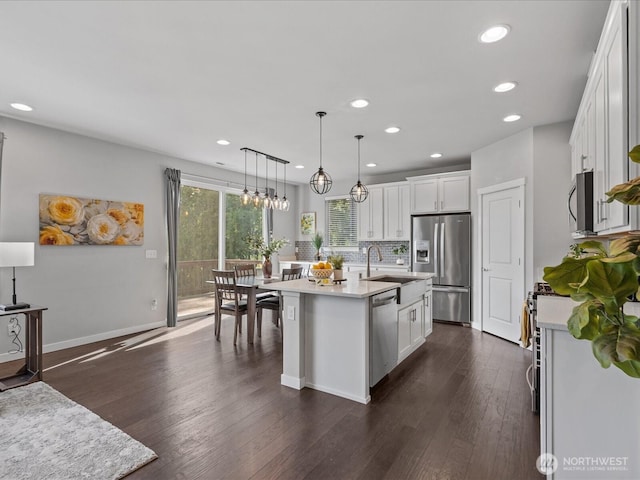kitchen featuring appliances with stainless steel finishes, a sink, recessed lighting, light countertops, and white cabinetry