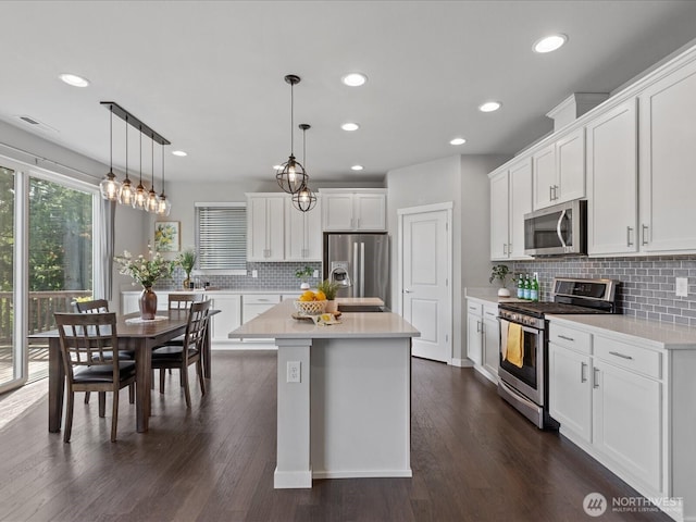 kitchen with stainless steel appliances, tasteful backsplash, light countertops, white cabinets, and recessed lighting