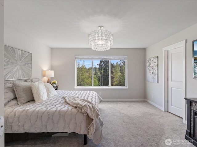 bedroom featuring a chandelier, carpet flooring, and baseboards