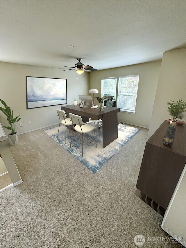 carpeted home office with ceiling fan