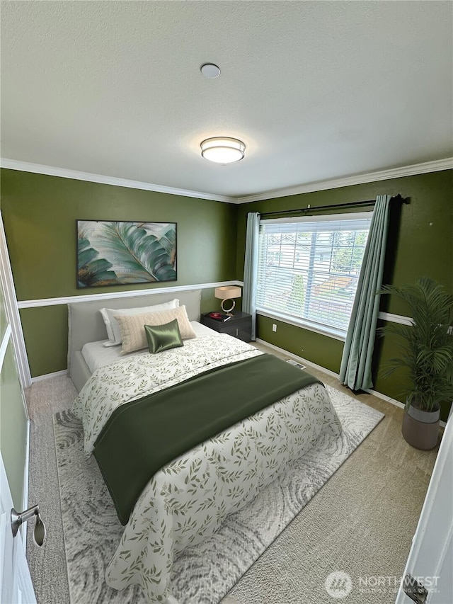 bedroom featuring baseboards, carpet flooring, and crown molding