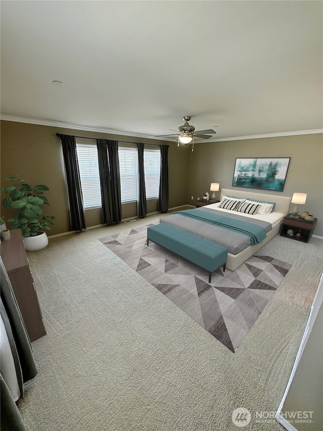 bedroom with carpet flooring, ornamental molding, baseboards, and ceiling fan