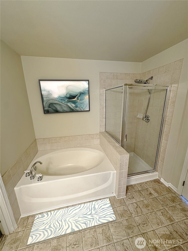 full bathroom with a garden tub and a shower stall