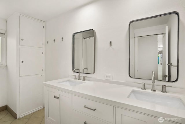 bathroom featuring double vanity and tile patterned floors
