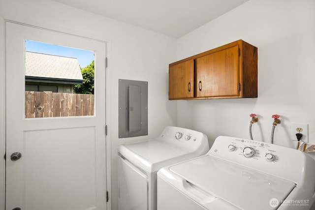 laundry room with cabinet space, electric panel, and independent washer and dryer