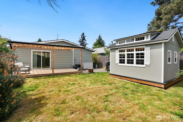 back of property featuring an outbuilding and a wooden deck