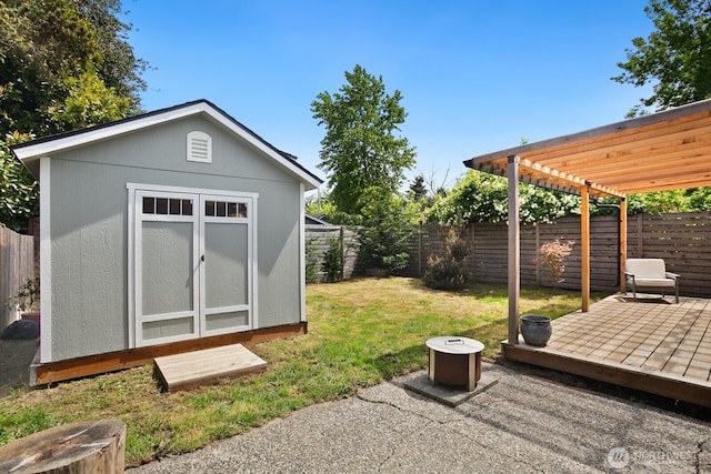 view of yard with a storage shed, an outdoor structure, and a deck