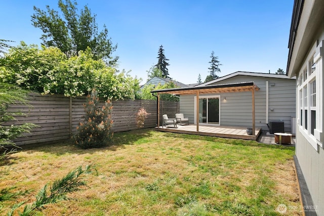 view of yard with a deck and central AC unit