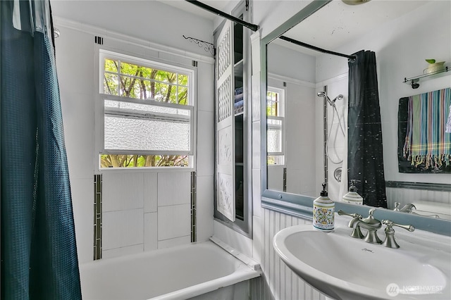 full bath featuring a sink, a bath, and a shower with curtain