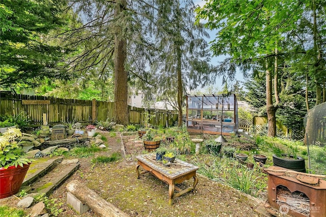 fenced backyard with a vegetable garden