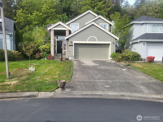 view of front of home featuring asphalt driveway, a front yard, a garage, and brick siding