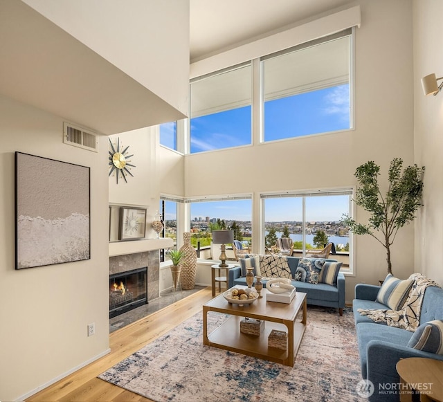 2400 Aurora Ave N Unit 202, Seattle, WA 98109 - living room with a towering ceiling, wood finished floors, and a fireplace