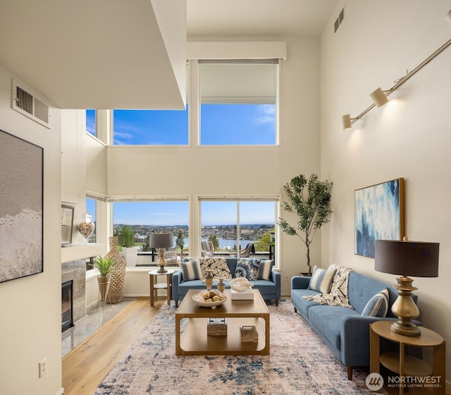 2400 Aurora Ave N Unit 202, Seattle, WA 98109 - living room with wood finished floors, a high end fireplace, plenty of natural light, and a high ceiling