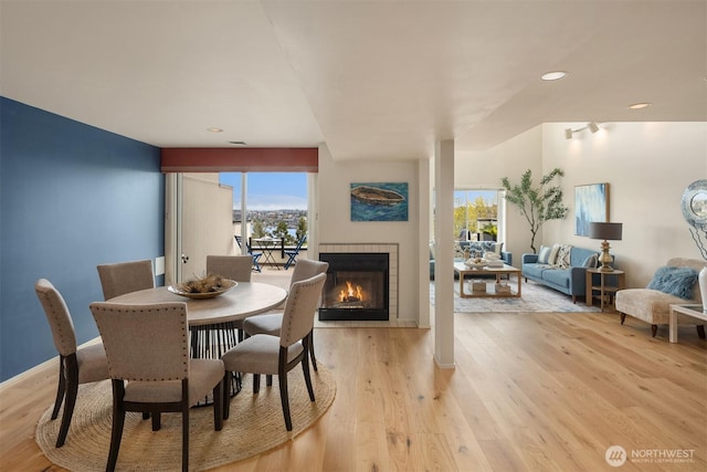 2400 Aurora Ave N Unit 202, Seattle, WA 98109 - dining space with light wood-style floors, a fireplace, baseboards, and recessed lighting