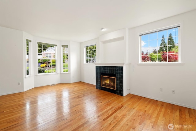 5007 70th Avenue Ct W Unit 7A, University Place, WA 98467 - unfurnished living room with a fireplace, light wood-style floors, and baseboards