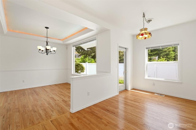 5007 70th Avenue Ct W Unit 7A, University Place, WA 98467 - unfurnished dining area featuring a chandelier, light wood finished floors, and baseboards