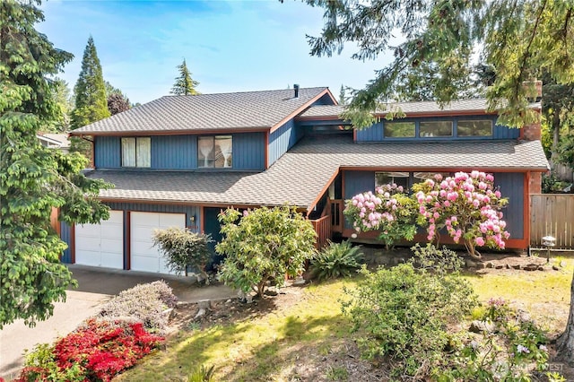 15915 SE 166th Pl, Renton, WA 98058 - view of front of house featuring an attached garage, concrete driveway, a shingled roof, fence, and a chimney