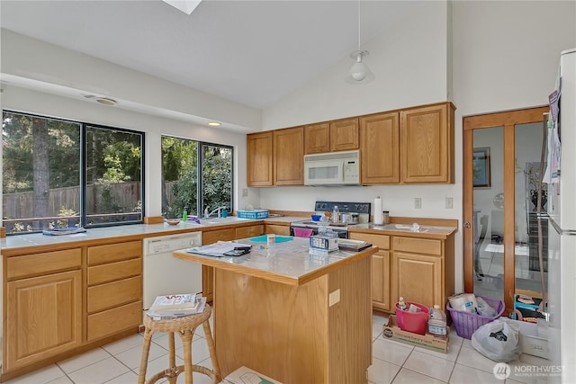 15915 SE 166th Pl, Renton, WA 98058 - kitchen featuring white appliances, light tile patterned floors, a center island, a sink, and high vaulted ceiling