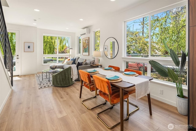 972 NW 54th St, Seattle, WA 98107 - dining room featuring a wall mounted AC, light wood-style floors, baseboards, healthy amount of natural light, and recessed lighting