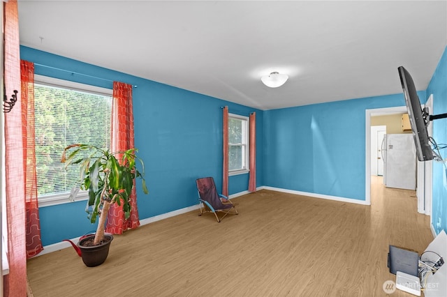 unfurnished room with wood finished floors and baseboards