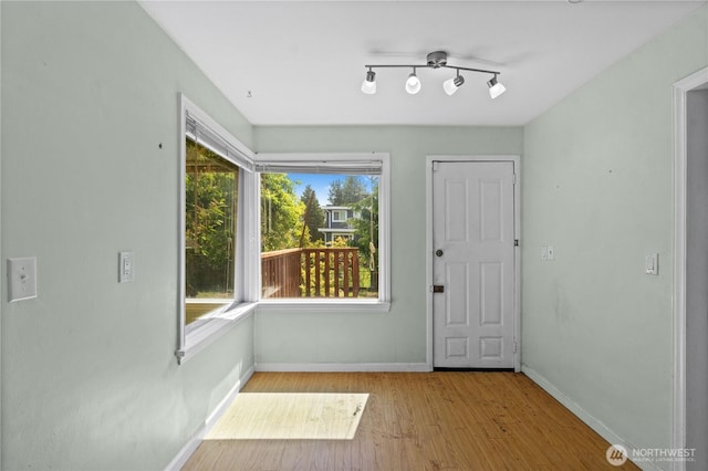 entryway featuring wood finished floors and baseboards