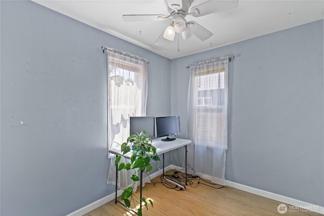 office area featuring baseboards, wood finished floors, and a ceiling fan