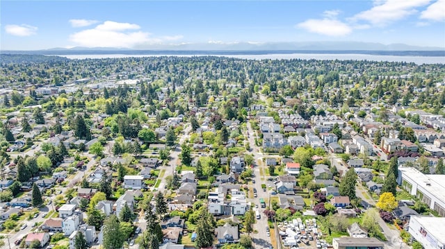 aerial overview of property's location featuring a water and mountain view and nearby suburban area