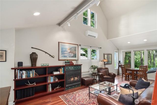 1503 Z St, Port Townsend, WA 98368 - living area with a wall mounted air conditioner, lofted ceiling, wood finished floors, healthy amount of natural light, and recessed lighting