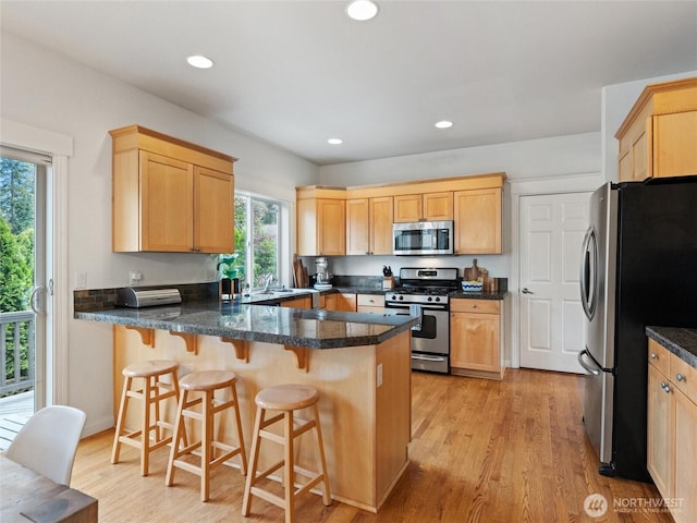22431 82nd Ave W, Edmonds, WA 98026 - kitchen with stainless steel appliances, light brown cabinets, a peninsula, light wood finished floors, and recessed lighting