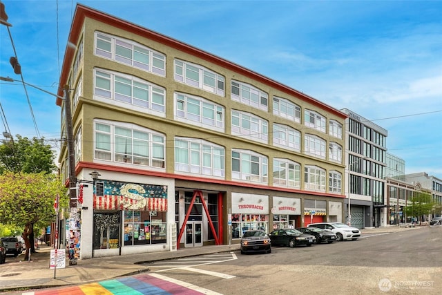 view of building exterior featuring uncovered parking
