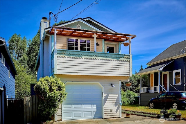 view of front of home featuring a chimney, fence, and a garage