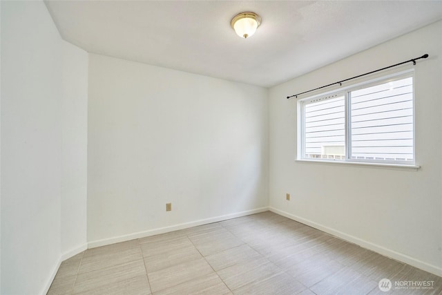 unfurnished room featuring baseboards