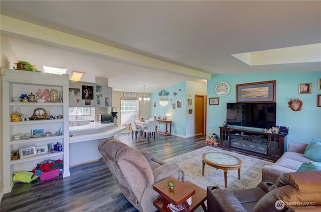 1510 144th Ln, Long Beach, WA 98631 - living room with dark wood-type flooring, a skylight, and baseboards