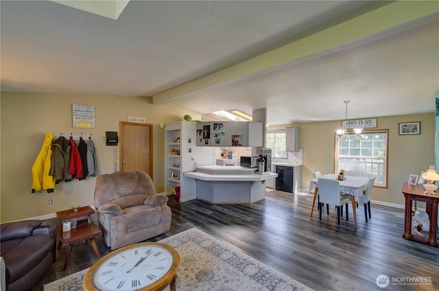 1510 144th Ln, Long Beach, WA 98631 - living room featuring dark wood-style flooring, baseboards, and a chandelier