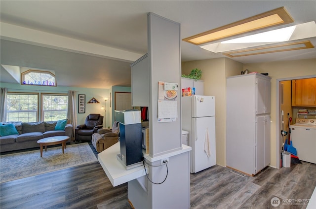 1510 144th Ln, Long Beach, WA 98631 - kitchen featuring washer / dryer, freestanding refrigerator, dark wood-style floors, and light countertops