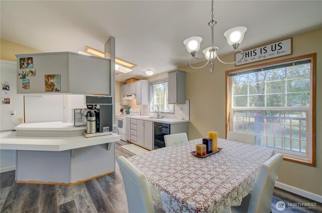 1510 144th Ln, Long Beach, WA 98631 - dining space with a chandelier, dark wood finished floors, and baseboards