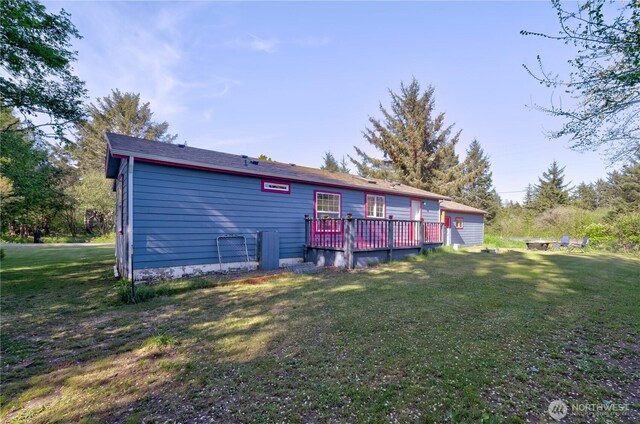 1510 144th Ln, Long Beach, WA 98631 - back of house with a wooden deck and a lawn